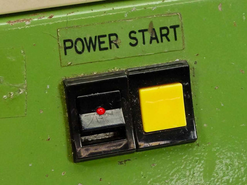 Close-up of TP-125mk2 Power Start panel showing black toggle switch with red indicator light and yellow push button