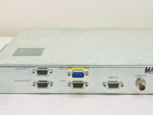 General Instrument Magnitude DVB Scrambling Unit – left side panel detail showing SYS SUP IN, SYS SUP OUT, CAE IN, TEST, and MUX IN DB-9 connectors and CLOCK IN BNC