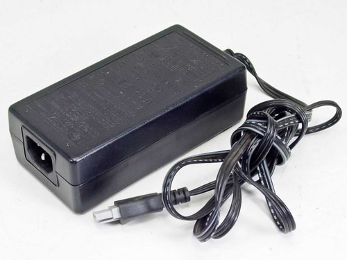 HP 0957-2153 AC Power Adapter – three-quarter front view showing black brick body, IEC C14 inlet, and output cable