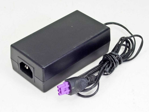 HP 0950-4476 AC power adapter — three-quarter front view showing black housing and purple output connector with attached cable