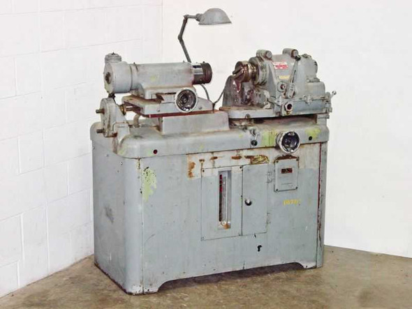 Autoflow Engineering 3173 optical lens polishing lathe — full front-left view showing grey cabinet base, spindle assembly, and work lamp