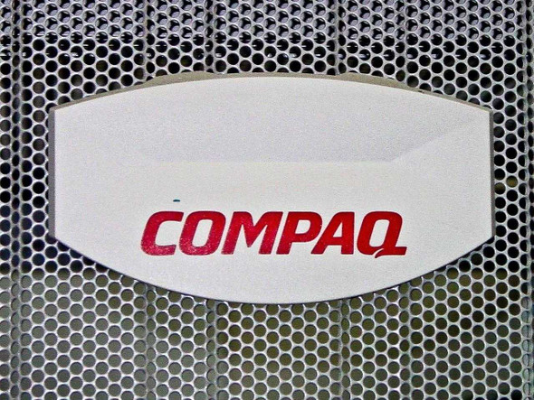 Compaq logo badge close-up on perforated mesh front door panel