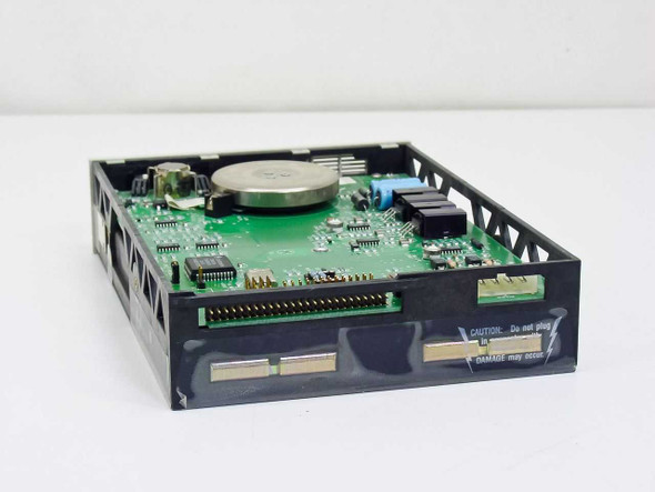 Iomega Beta 90B SCSI optical drive – rear-angled top view showing full PCB layout, capacitors, and caution label on rear panel