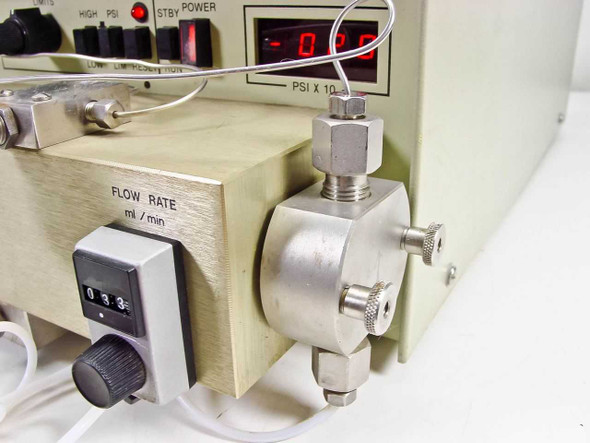 LDC ConstaMetric III G pump right side showing FLOW RATE ml/min mechanical dial set to 0.33 and stainless steel reciprocating pump head with fittings