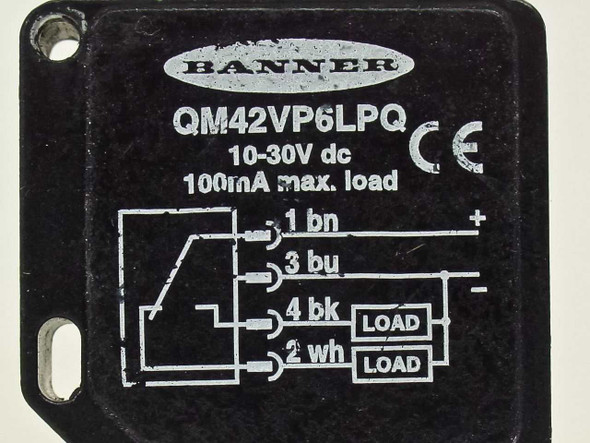 Banner QM42VP6LPQ photoelectric sensor — top label close-up showing model, 10-30V DC, 100mA max load rating, and wiring diagram with pin assignments