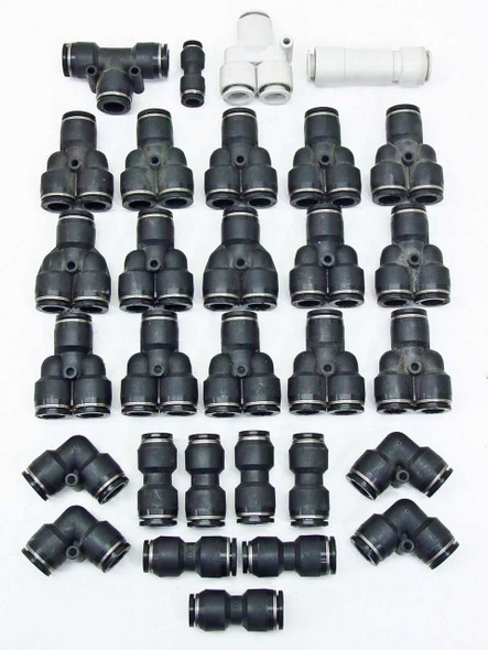 SMC push-to-connect pneumatic fittings lot — full spread showing T, Y, elbow, straight union, and splitter connectors in black and white