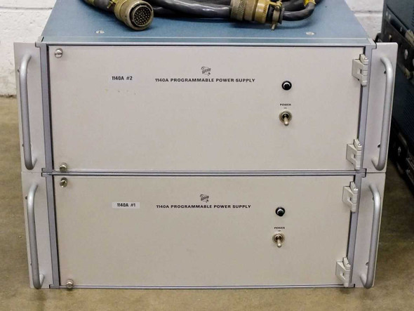 Two Tektronix 1140A Programmable Power Supply units stacked — front panel view showing unit labels '1140A #2' and '1140A #1' with key switches and indicator lights