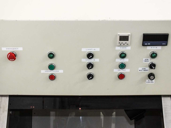 Right-side control panel close-up showing emergency stop, light controls, spin controls, Fuji MD4E timer, and RPM display