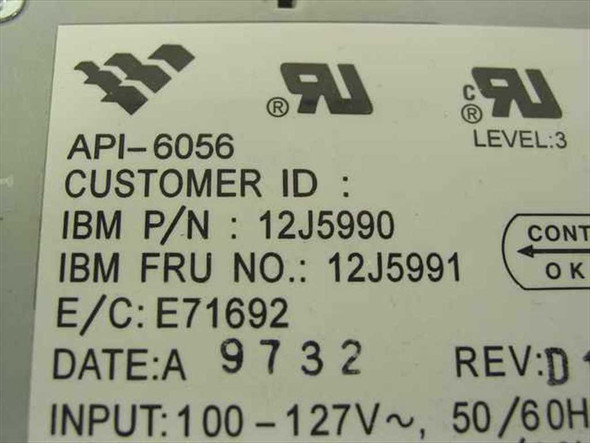 IBM API-6056 power supply label closeup showing IBM P/N 12J5990, FRU 12J5991, E/C E71692, Date 9732, Rev D, and 100-127V 50/60Hz input specification