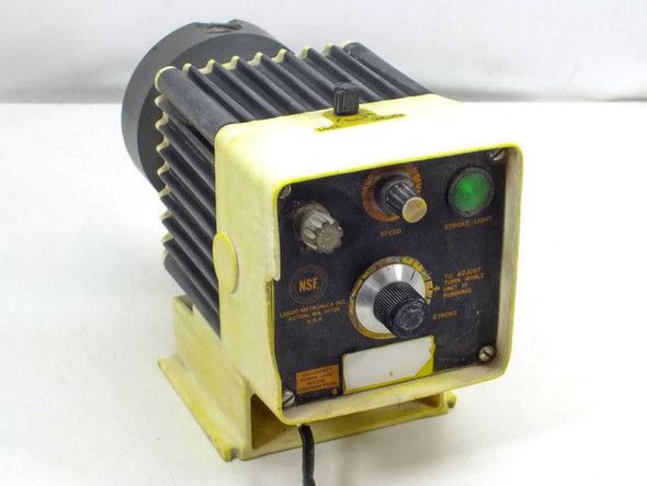 Liquid Metronics electromagnetic dosing pump front panel view showing speed control knob, stroke adjustment knob, stroke indicator light, and NSF label