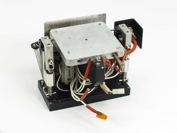 Steag Firstlight heating element — rear-left view showing orange high-temperature wiring, white multi-pin connector, and spring-loaded lifting mechanism