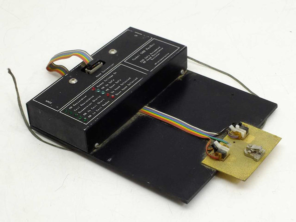 AMG Test Engineering 500 ResBox MR Head Resistance Switcher – three-quarter view showing main control unit, ribbon cable harness, and attached head test fixture board on black base plate