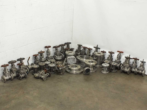 Full lot of 45 Powell and mixed-brand stainless steel flanged gate valves and fittings arranged on warehouse floor