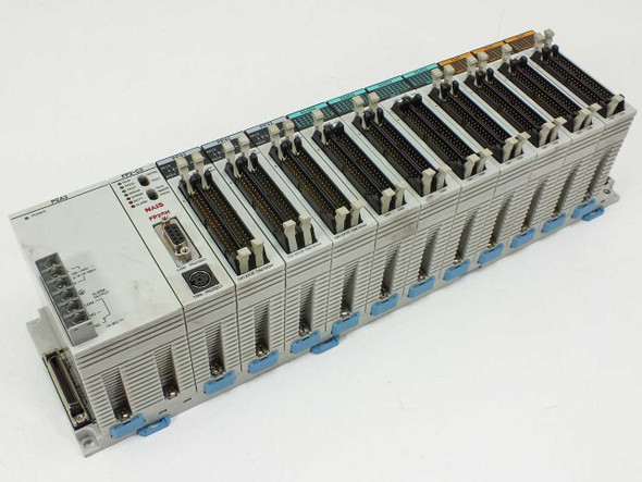 NAIS FP2-BP14 14-slot PLC backplane with all modules installed — front left angled view showing PSA3, FP2-C2, PP42, X64D2, and Y64T modules