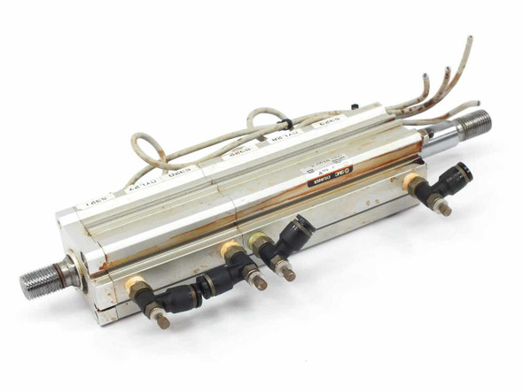SMC compact pneumatic cylinder pair – side view showing push-in fittings and pneumatic tubing ports along the bottom