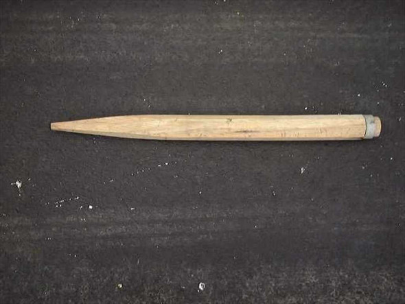 US Tucker military wooden tent stake showing tapered point and metal band at top — side profile view