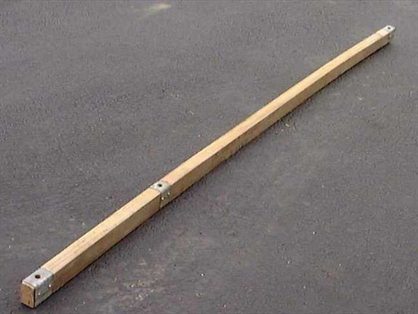 US Tucker military ridge tent pole angled view showing natural wood construction, metal corner caps at both ends, and mounting holes