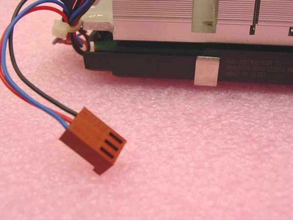 Intel Pentium II SEC cartridge close-up showing fan power connector wiring and label detail on cartridge edge