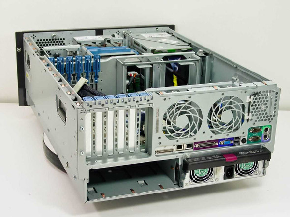 HP ProLiant ML370 tower server – angled rear-left view showing motherboard, PCI expansion slots, redundant power supply, and rear fan housings
