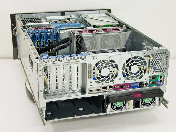 HP ProLiant ML370 interior top-down view showing dual-processor motherboard, expansion slots, redundant PSUs, and cabling