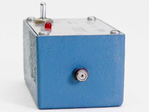 BBN Instruments P16 Supply Box side view showing top-mounted toggle switch, red LED indicator, and small SMA-style connector on the side face of the blue metal enclosure