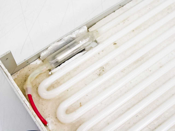 Light Grid Assembly C15186-1 — close-up of lamp tubes and foil-wrapped component showing dust and wear