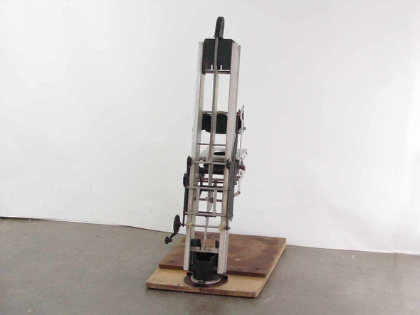 Simmon Bros Automega B7 Enlarger rear view showing column rails, rack-and-pinion gear mechanism, and crank knob