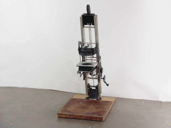 Simmon Bros Automega B7 Photographic Enlarger full front view showing column, lens stage, bellows, and wood baseboard