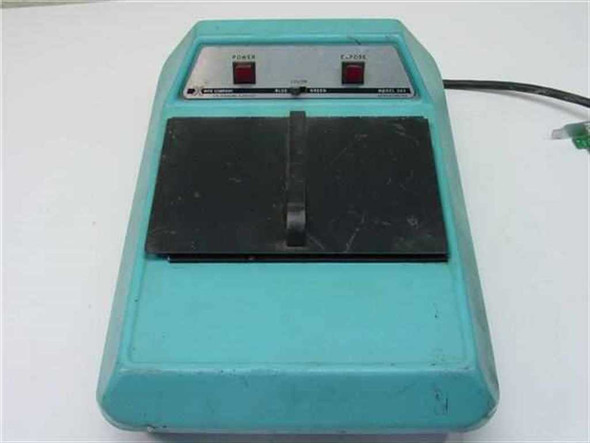 X-Rite 303 Sensitometer front view showing teal housing, black film platen, Power and Expose buttons on brushed-metal panel