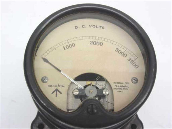 Close-up of voltmeter dial face showing D.C. VOLTS scale 0-3500, moving coil pointer, serial number, and 1945 date marking