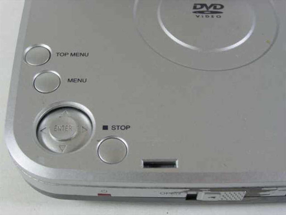 Initial IDM-9530 portable DVD player top panel showing Top Menu, Menu, Enter navigation pad, and Stop button controls
