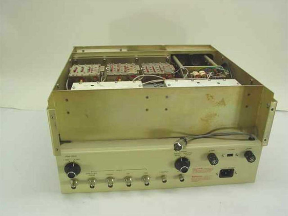 Carnel Labs NM-65T – rear and right side view showing IEC AC inlet, rear BNC connectors, and internal chassis with wiring visible; top cover absent