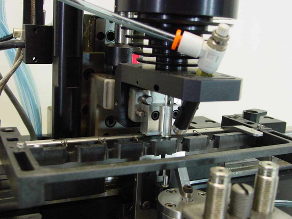Applied Magnetics SFL Grammer 559883 — close-up of head alignment tooling and pneumatic actuator assembly with precision fixtures