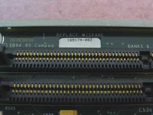 Close-up of Compaq 169174-002 board edge label showing part number 169174-002, 1994.95 Compaq date code, REPLACE W/SPARE marking, and SIMM connector banks