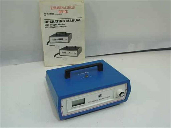Ventronics 5529 Digital Oxygen Analyzer front panel view with LCD display and operating manual behind it