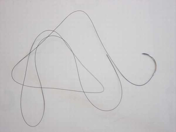 Ethicon 662 Ethilon 4-0 nylon suture thread with curved FS-2 cutting needle laid out full length on white background
