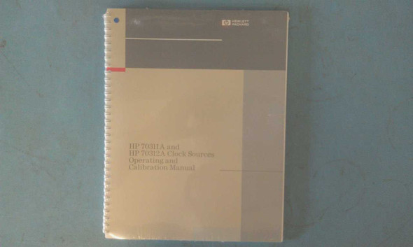 HP 70311A and 70312A Clock Sources Operating and Calibration Manual – front cover view showing spiral-bound manual with HP Hewlett-Packard logo and title text