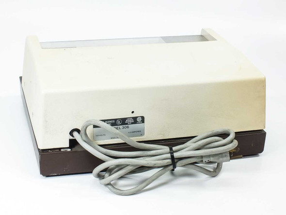 NBS Model 306 card imprinter – rear view showing rating label and attached power cord