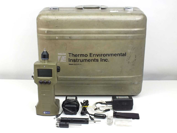 Thermo Environmental 580 EZ organic vapor meter with hard carry case, 2 probes, charger with wall and car adapters, and lamp cleaner laid out in front