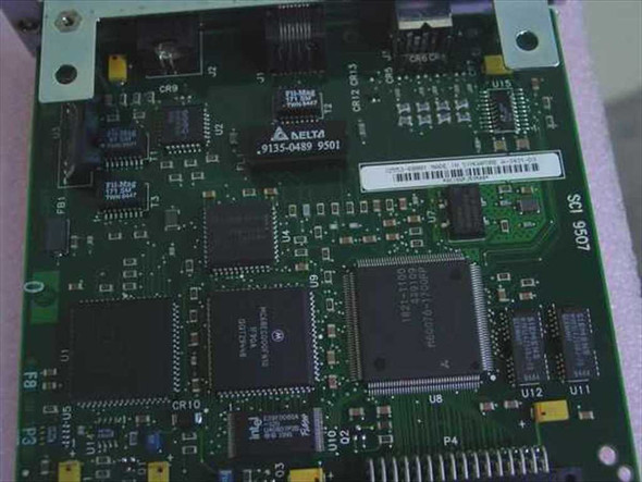 HP J2553-60001 JetDirect card PCB rear view showing Delta transformer, main controller ICs, and barcode label