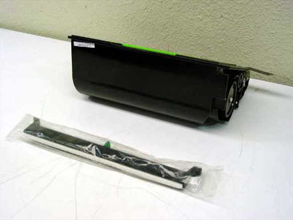 Sharp FO-48ND toner cartridge – side view showing cartridge body with label and sealed developer strip bag alongside