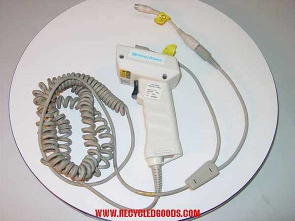 Pitney Bowes J762 PB-J762-R handheld laser barcode scanner with coiled cable and PC wedge Y cable attached, top view on white surface