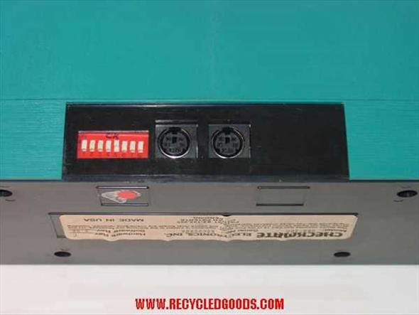 Checkmate Electronics SMR-300 rear panel showing two Mini-DIN ports, 8-position DIP switch bank, and Made in USA label