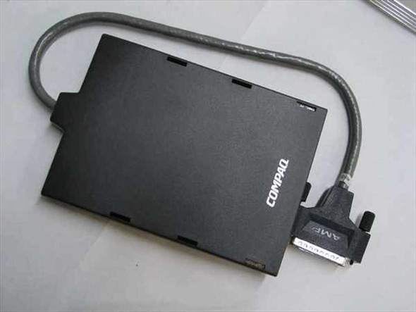 Compaq 258575-002 external floppy drive caddy top view with Compaq logo and AMP parallel connector