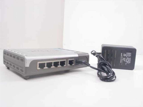 D-Link DI-604 rear panel showing four RJ-45 LAN ports and one WAN port with AC adapter connected