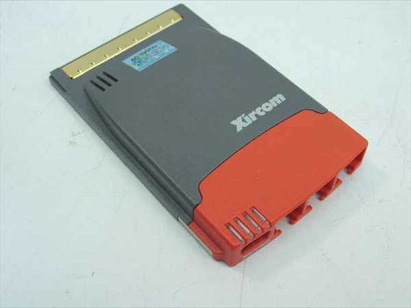 Xircom RBEM56G-100 RealPort CardBus combo card — top view showing CardBus gold-contact edge connector and Xircom logo with red dongle attached