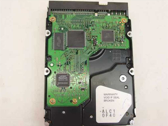 Quantum Fireball lct 15 hard drive PCB board view showing Lucent Quantum controller chip, warranty seal label reading ALC1 0F40