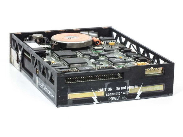 Iomega Beta 150A – rear/side view of drive interior showing PCB, caution label warning not to plug in connector with power on