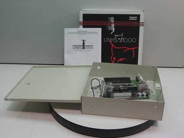 DSC SG Security Communications Links 1000 cellular alarm transmitter shown with original box, warning sheet, and open metal enclosure revealing PCB and components