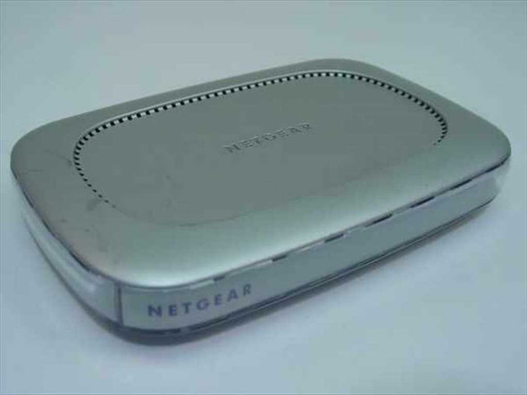 Netgear FS608 8-Port Fast Ethernet Switch — top view showing silver housing and ventilation slots